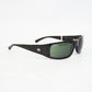 Ray-Ban wraparound sunglasses with a glossy black acetate frame and dark green lenses, displayed on a white textured surface.