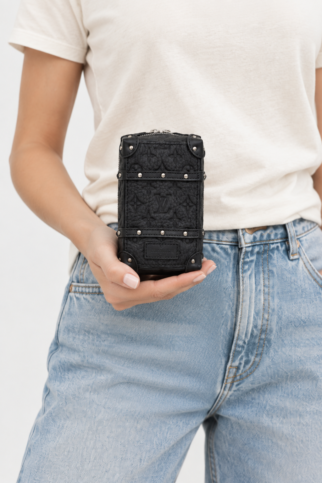 Revised studio image of model holding the charm bag